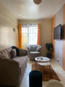 a living room with a couch and a table at Shikaz Homes Two bedroom in Nairobi