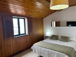 a bedroom with a bed and a window at AZORES PEDRA APARTMENTS - T0 e T1 in Ponta Delgada