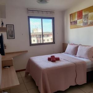 a bedroom with a bed with a red towel on it at Apt 2 Suítes no Life Resort com Vista parcial para o Lago e lazer completo in Brasilia +45 photos