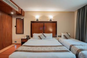 Postel nebo postele na pokoji v ubytování Park Avenue Hotel Nungambakkam