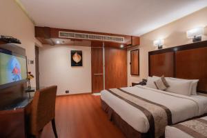Postel nebo postele na pokoji v ubytování Park Avenue Hotel Nungambakkam