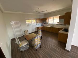 a kitchen with a table and two chairs and a table at Farm House Angoori Hill Near Bahria Golf City in Rawalpindi +8 photos