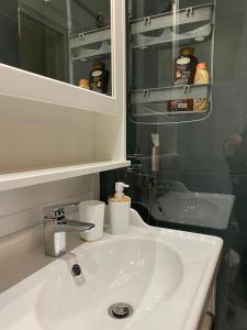 a bathroom with a white sink and a mirror at Casa Vacanza La Molaretta di San Teodoro in San Teodoro