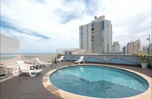 a swimming pool on the roof of a building at Flatguarapari in Guarapari