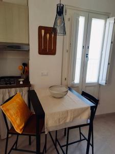 a kitchen with a table with a bowl on it at Dimora Giannuzzi in Conversano +7 photos