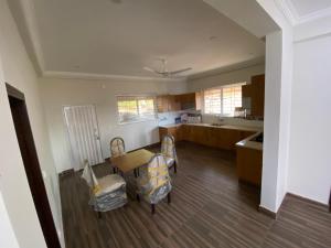 a kitchen with a table and chairs in a room at Farm House Angoori Hill Near Bahria Golf City in Rawalpindi