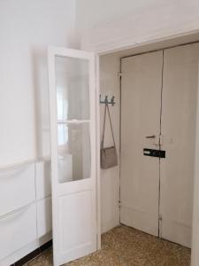 a white door in a room with a closet at La Cà De Zan in Mezzegra +39 photos