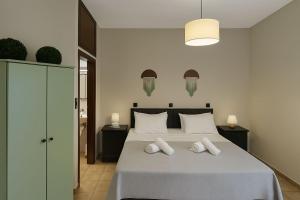 a bedroom with a bed with two white pillows at Nicolas Beach in Palaiochora