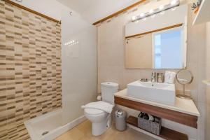 a bathroom with a toilet and a sink and a mirror at La Punta in Alcalá
