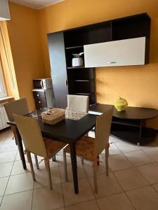 a dining room with a black table and chairs at Casa di Amalia 14 in Biella +12 photos