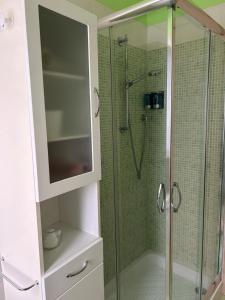 a bathroom with a shower with a glass door at Casa di Amalia 14 in Biella +12 photos