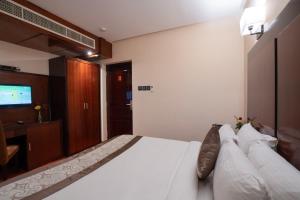 Postel nebo postele na pokoji v ubytování Park Avenue Hotel Nungambakkam