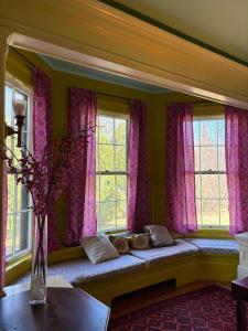 a window seat in a room with purple curtains at The Converse Castle in Norwich +69 photos
