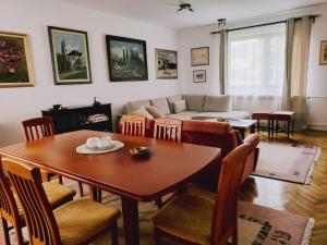 a living room with a table and chairs and a couch at ZIA -Kuća za odmor in Vrbanja
