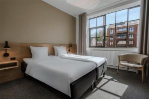 Katil atau katil-katil dalam bilik di Radisson Hotel Papirfabrikken Silkeborg