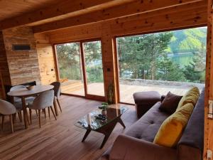 a living room with a couch and a table at Zaovinska idila in Bjeluša