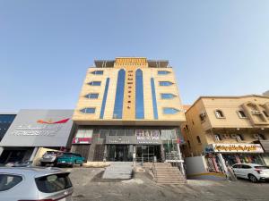 a tall building with blue and yellow stripes on it at فندق نجمة روز الفندقيه Rose Star Hotel in Jeddah