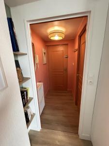 a hallway with orange walls and a door at Studio Douce Brise in Dunkerque