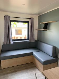 a bench in a room with a window at Camping LE MOULIN DE CAUDON in Domme