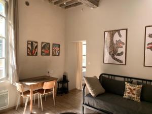 a living room with a couch and a table at La Picholine in Uzès