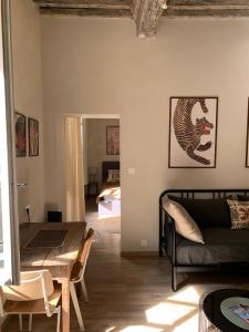 a living room with a couch and a table at La Picholine in Uzès