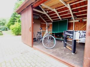 a bike parked inside of a building with a garage at Gaestehaus-Bruhn-6 in Alkersum