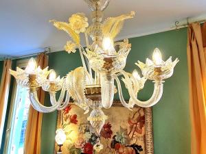 a chandelier hanging from a ceiling in a room at Allegretto Rialto in Venice