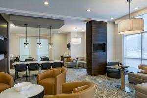 a living room with a table and chairs and a dining room at Residence Inn by Marriott Tallahassee Universities at the Capitol in Tallahassee