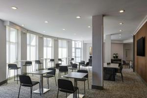a waiting room with tables and chairs and windows at Residence Inn by Marriott Tallahassee Universities at the Capitol in Tallahassee +24 photos