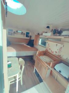 a small room with a table and a bed and a table and chair at Ekokemp Lipa in Štiavnické Bane +9 photos