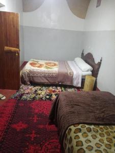 Postel nebo postele na pokoji v ubytování Dar Laayoune
