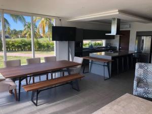 a kitchen with a wooden table and benches in a room at Three New Beautiful Villas In Punta Cala in Nuevo Vallarta 