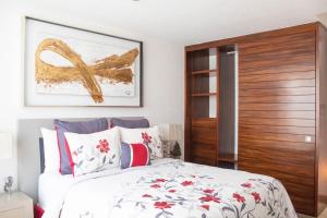 a bedroom with a bed with a wooden door at Three New Beautiful Villas In Punta Cala in Nuevo Vallarta  +42 photos