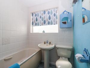 a bathroom with a sink and a tub and a toilet at Ambermist in Kingsbridge +14 photos