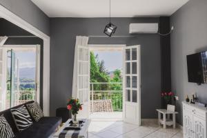 カロウセイズにあるCozy 2 Bedrooms Apartment on the Hill w/Netflixのリビングルーム(バルコニーにつながるドア付)