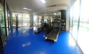 a gym with blue flooring and a gym with machines at Studio at Kris Condo walk to Bangtao beach 2304 in Bang Tao Beach +5 photos