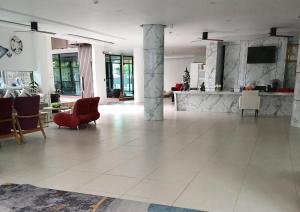 a large living room with a red chair and a table at Studio at Kris Condo walk to Bangtao beach 2304 in Bang Tao Beach