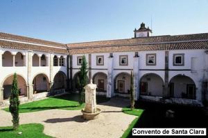 a large building with a courtyard with a clock tower at Maison Garrett in Portalegre