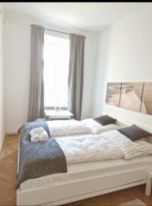 a bedroom with two beds and a large window at Rrpp in Vienna