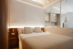 A bed or beds in a room at Newly Renovated Stylish Eixample - Great Location