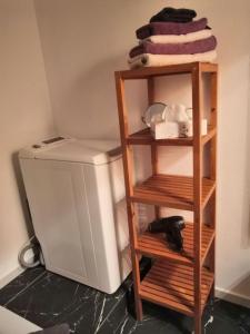 a wooden shelf next to a small refrigerator at Ferienwohnungen Schelhas in Prien am Chiemsee
