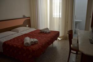 Postel nebo postele na pokoji v ubytování Hotel Artide