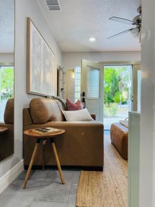 a living room with a couch and a table at 3BR Oasis DT ORL, Full Kitchen & Fenced Yard! in Orlando