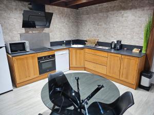 a kitchen with a glass table in the middle of it at Les Résidences primevère in Cayenne