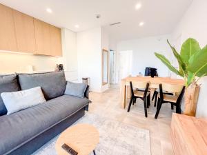 a living room with a couch and a table at El Campello Ocean View Escape in La Venteta