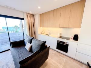 a living room with a couch and a kitchen at El Campello Ocean View Escape in La Venteta +16 photos