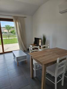 a dining room with a wooden table and chairs at L'Ardèchois in Saint-Remèze