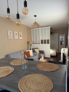 a living room with a table and a couch at La maison de villenouvelle in Toulouse
