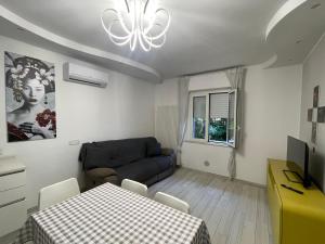 a living room with a table and a couch at Appartamento Lindo e Dora - A due passi dal mare in San Benedetto del Tronto
