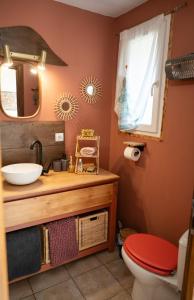 a bathroom with a sink and a toilet and a mirror at Les gardiens de la vallée in Figeac +28 photos